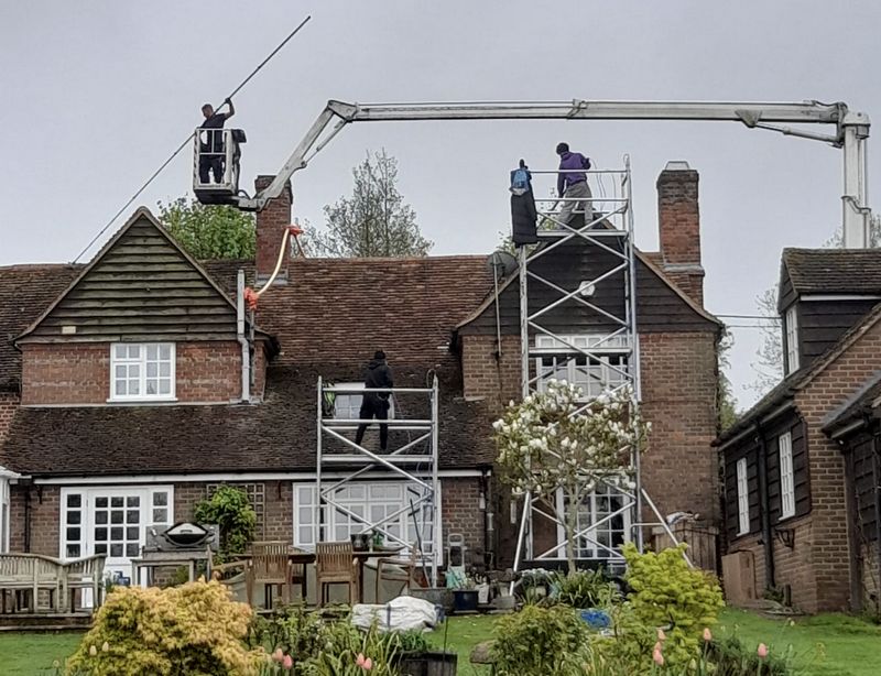 The Roof Moss Cleaners using cherry picker and scaffolding to clean roof safely and professionally in Bromham, Bedfordshire